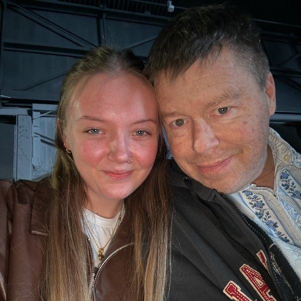 Old man and young woman taking a selfie.
